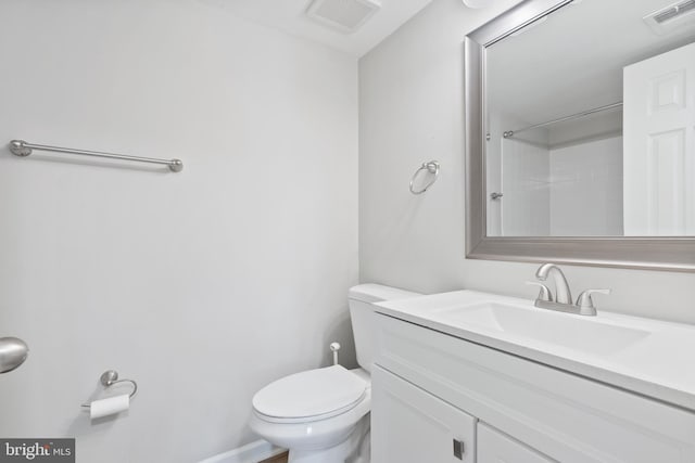 bathroom featuring visible vents, vanity, and toilet