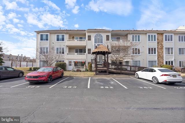 view of building exterior with uncovered parking