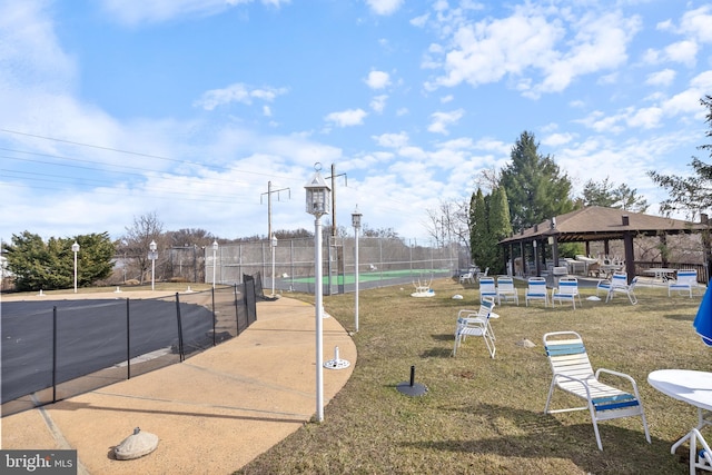 view of property's community featuring fence and a gazebo