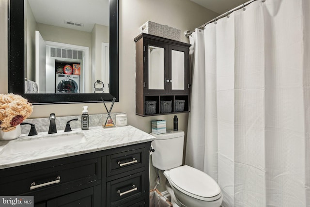 full bath featuring washer / clothes dryer, visible vents, vanity, and toilet