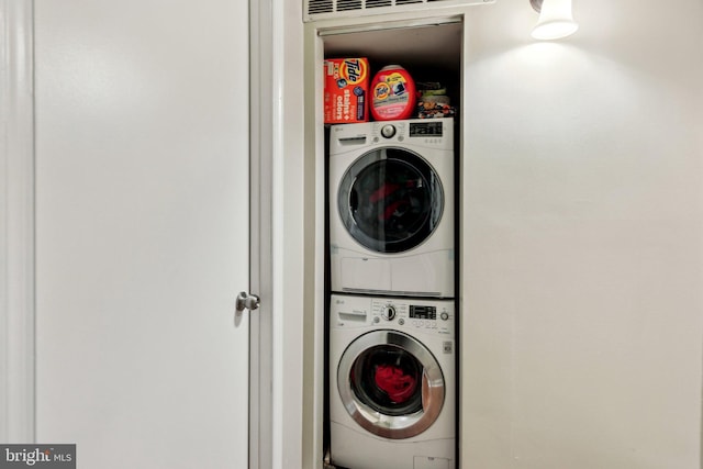 laundry area featuring stacked washer / drying machine