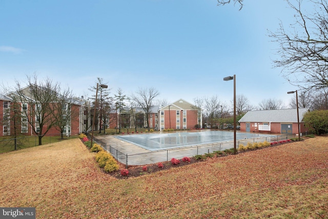 view of swimming pool featuring fence and a yard