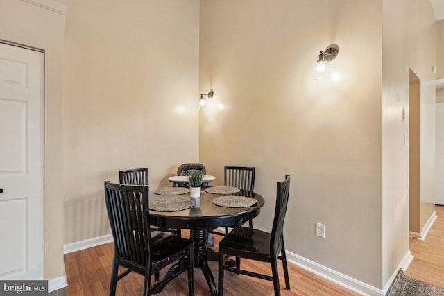 dining space with wood finished floors and baseboards