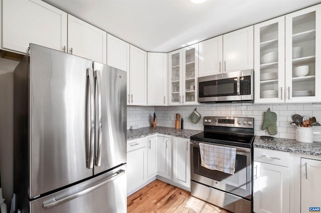 kitchen featuring stainless steel appliances and white cabinets