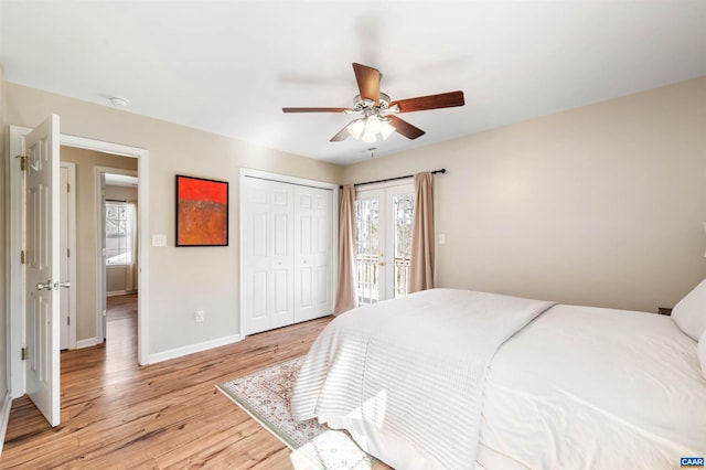 bedroom with access to exterior, a closet, light wood-style floors, a ceiling fan, and baseboards