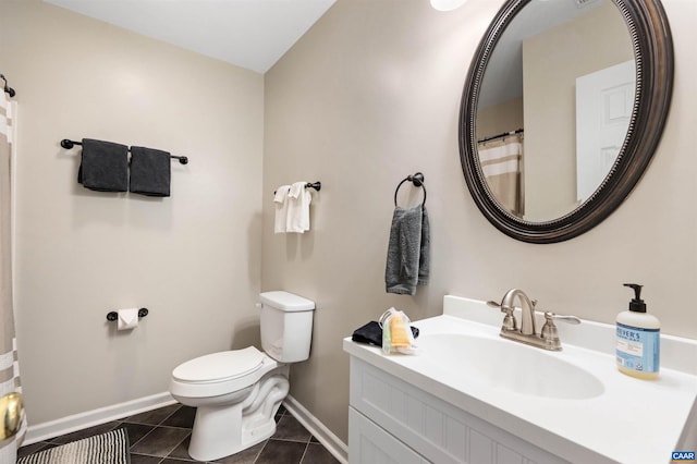 bathroom featuring tile patterned flooring, baseboards, vanity, and toilet