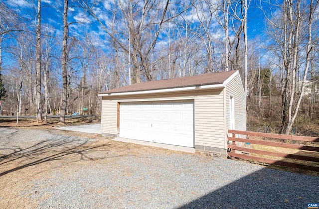 detached garage featuring fence