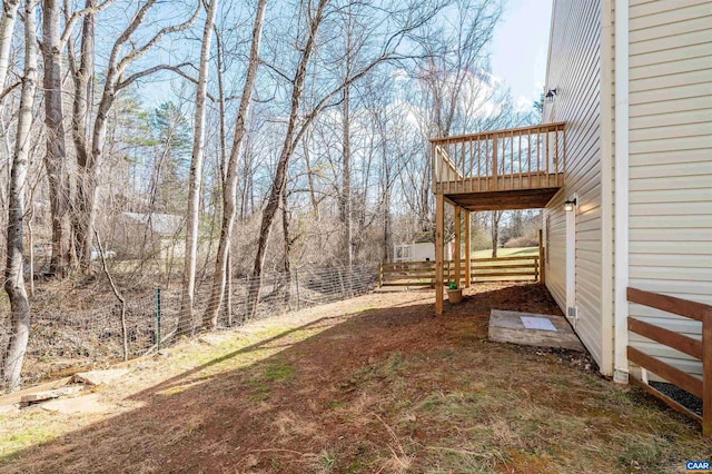 view of yard with fence and a wooden deck