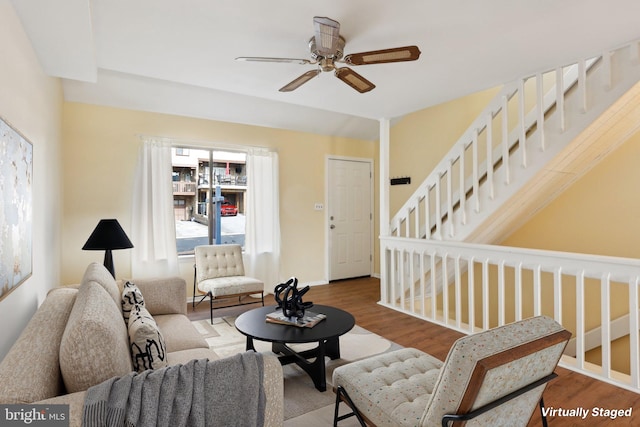 living area with ceiling fan, wood finished floors, and baseboards