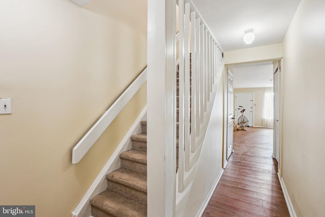 stairs featuring baseboards and wood finished floors