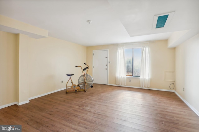 spare room featuring baseboards and wood finished floors