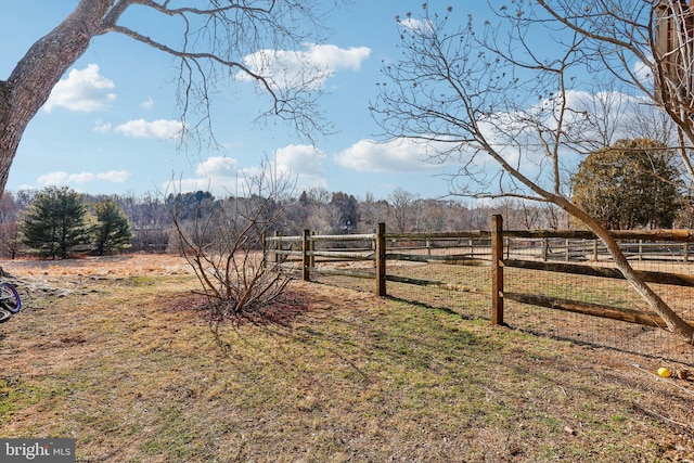 view of yard featuring a rural view and fence