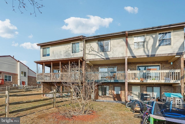 view of front of home with brick siding and fence