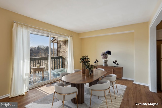 dining room featuring baseboards and wood finished floors