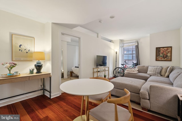 living area featuring baseboards and dark wood-style flooring