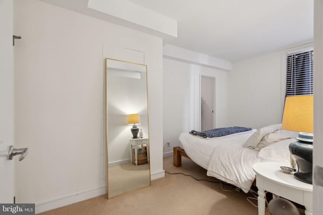 bedroom featuring baseboards and carpet