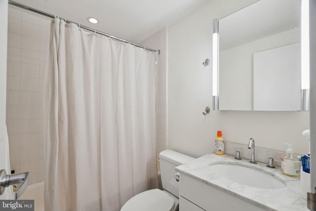 full bath with toilet, vanity, and shower / bath combination with curtain