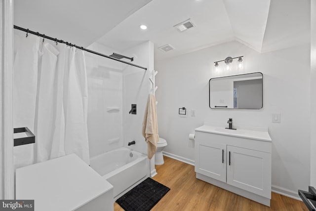 bathroom with toilet, shower / bathtub combination with curtain, visible vents, and wood finished floors