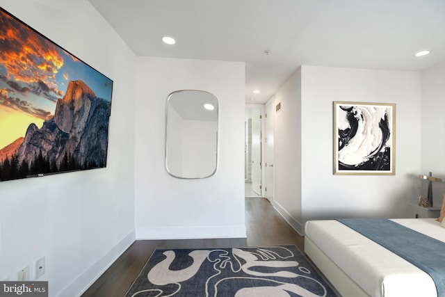 bedroom with visible vents, baseboards, wood finished floors, and recessed lighting