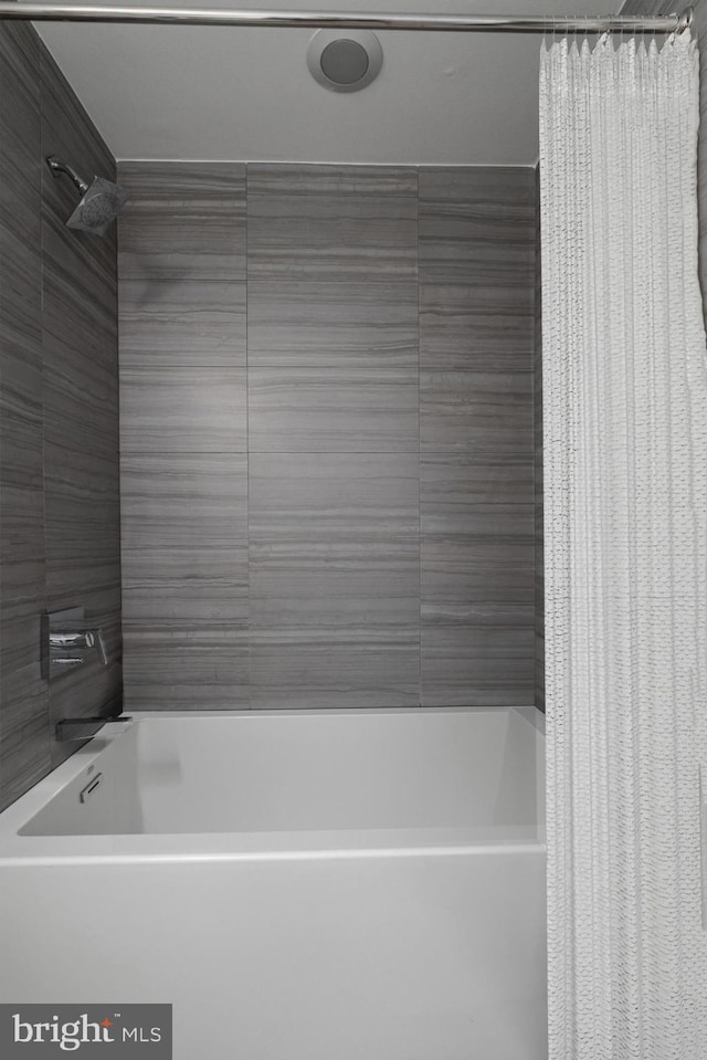 bathroom with shower / bath combination with curtain