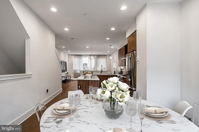 dining room featuring baseboards, dark wood finished floors, and recessed lighting