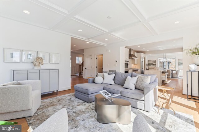 living area featuring recessed lighting, light wood-style floors, and coffered ceiling