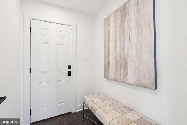 interior space featuring dark tile patterned flooring