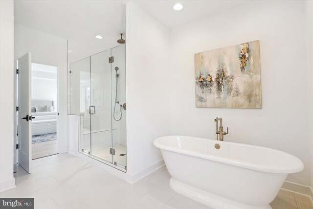 full bath featuring recessed lighting, a shower stall, a freestanding bath, and baseboards