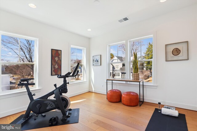 workout area featuring recessed lighting, wood finished floors, visible vents, and baseboards