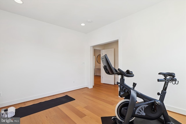 exercise area with recessed lighting, baseboards, and light wood finished floors