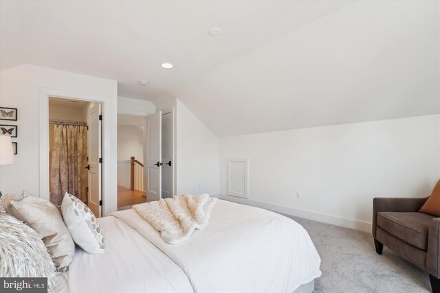 bedroom with lofted ceiling, recessed lighting, light colored carpet, and baseboards