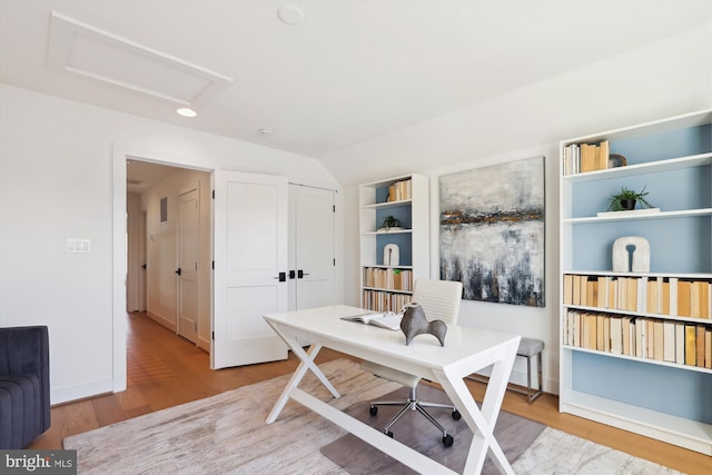 office featuring attic access, wood finished floors, and vaulted ceiling