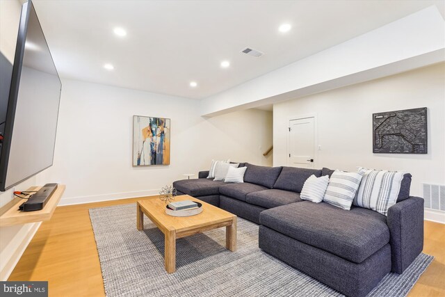 living area with recessed lighting, visible vents, and light wood finished floors