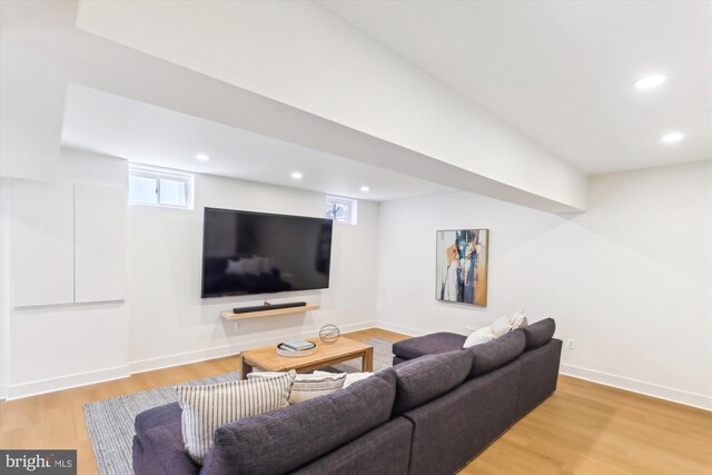 living area with recessed lighting, light wood-type flooring, and baseboards