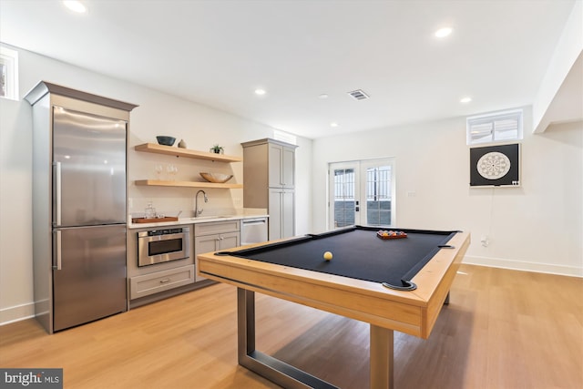 game room featuring visible vents, recessed lighting, a sink, light wood-style floors, and french doors