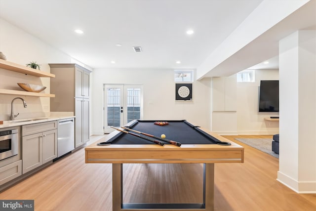 game room featuring visible vents, a wealth of natural light, french doors, light wood-style floors, and a sink