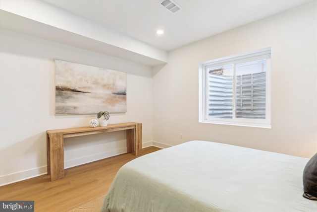 bedroom with visible vents, recessed lighting, baseboards, and wood finished floors