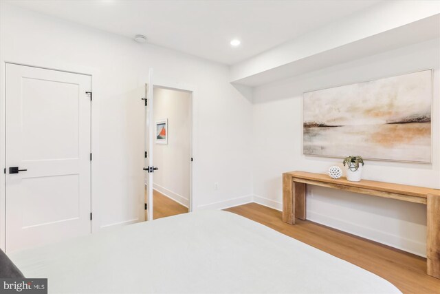 unfurnished bedroom featuring recessed lighting, baseboards, and wood finished floors