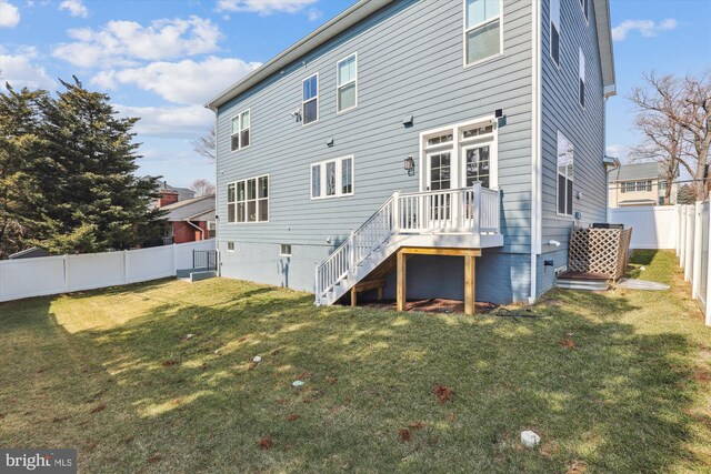 back of house featuring a fenced backyard and a yard