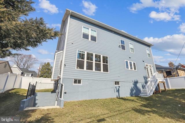 back of property featuring a fenced backyard and a yard