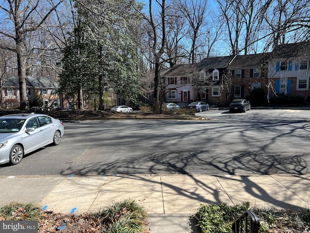 view of road with a residential view and sidewalks