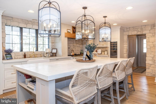 kitchen featuring open shelves, light wood-style flooring, white cabinets, and light countertops