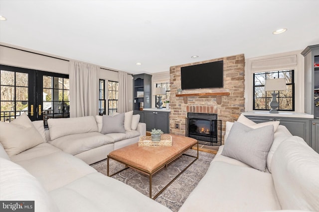 living room featuring recessed lighting and a fireplace