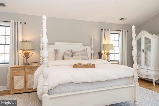 bedroom with visible vents and wood finished floors