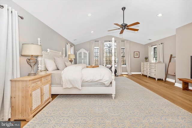 bedroom featuring lofted ceiling, recessed lighting, a ceiling fan, wood finished floors, and baseboards