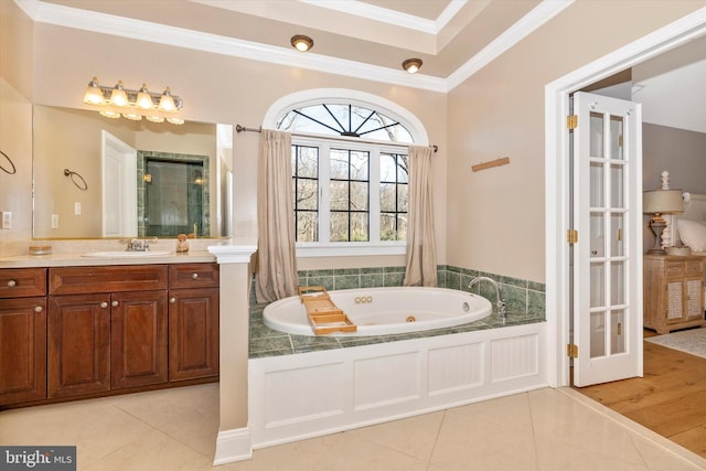 bathroom featuring a tub with jets, ornamental molding, and tile patterned flooring