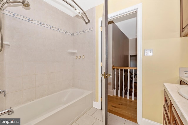 full bath with baseboards, vanity, shower / tub combination, and tile patterned floors