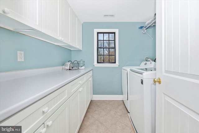 washroom with cabinet space, light tile patterned floors, visible vents, baseboards, and washing machine and dryer