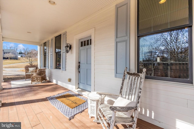 view of exterior entry featuring a porch