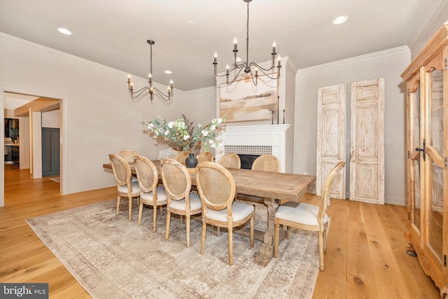 dining area featuring light wood-style floors, recessed lighting, and crown molding